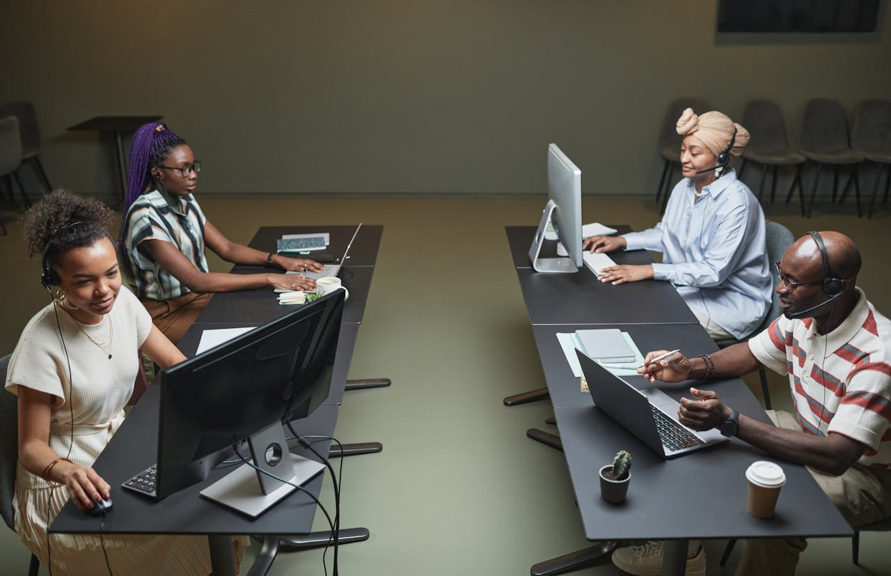 Diverse call center team collaborating in a modern office setting.